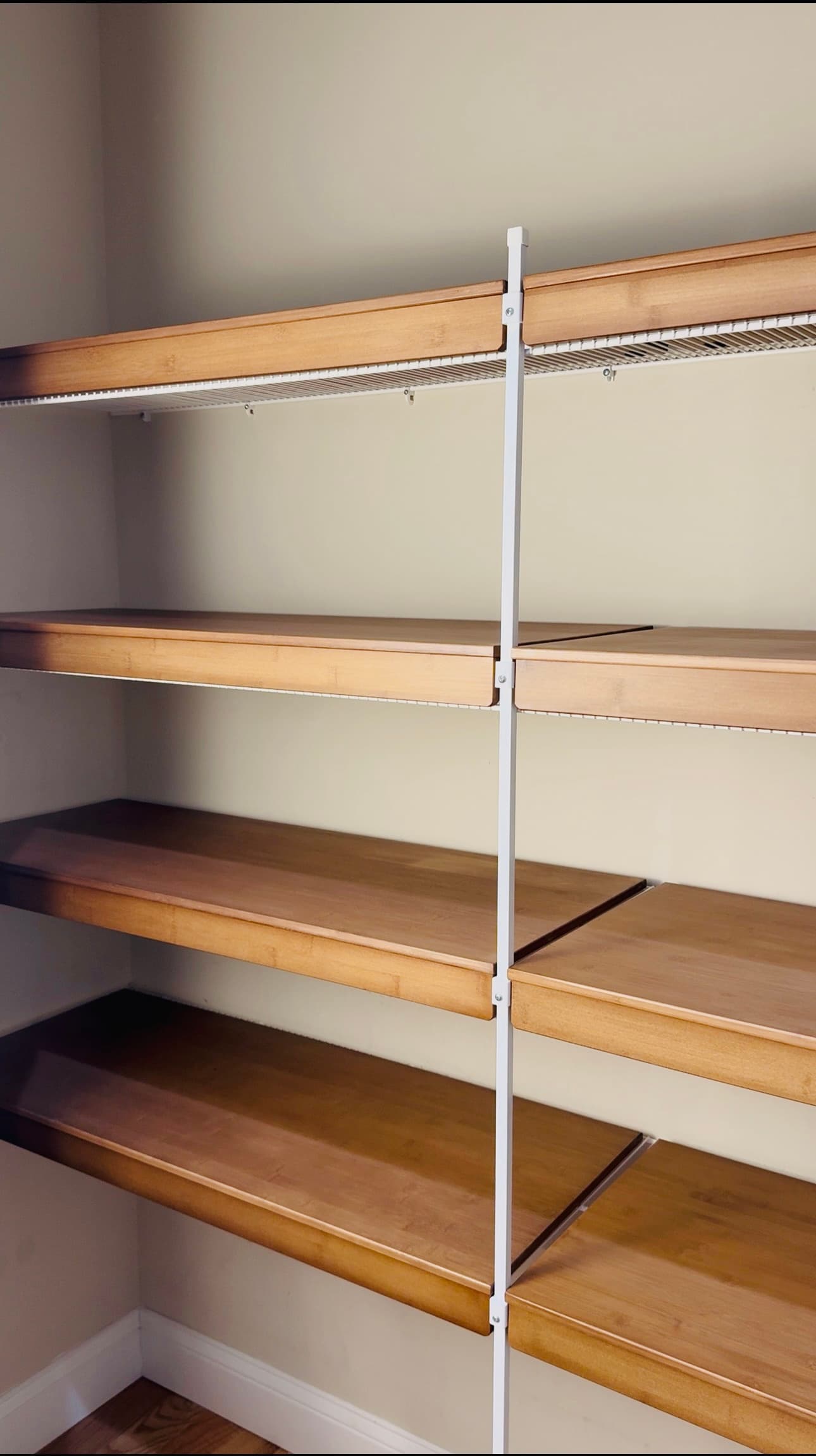 Empty pantry shelves with bamboo wire rack covers installed, before storage is added
